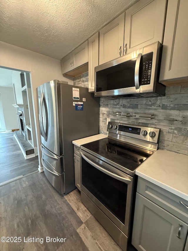 386 Pine Ridge Dr, Brandenburg, KY 40108 - kitchen with decorative backsplash, light countertops, dark wood finished floors, appliances with stainless steel finishes, and gray cabinets