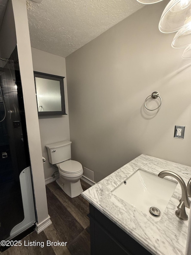 386 Pine Ridge Dr, Brandenburg, KY 40108 - full bath with vanity, toilet, a textured ceiling, a stall shower, and wood finished floors