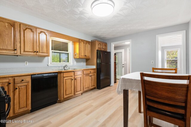 6515 Upper Hunters Trce, Louisville, KY 40216 - kitchen with plenty of natural light, light countertops, light wood-style flooring, and black appliances