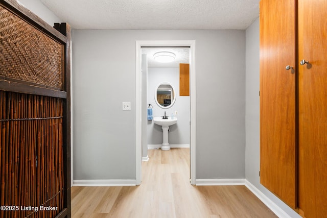 6515 Upper Hunters Trce, Louisville, KY 40216 - corridor with baseboards, a textured ceiling, and wood finished floors