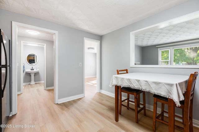 6515 Upper Hunters Trce, Louisville, KY 40216 - dining area featuring light wood-style floors and baseboards