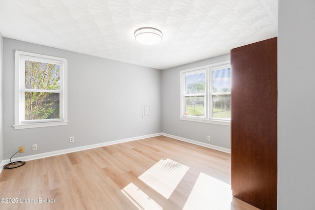 6515 Upper Hunters Trce, Louisville, KY 40216 - empty room with plenty of natural light, light wood-style floors, and baseboards