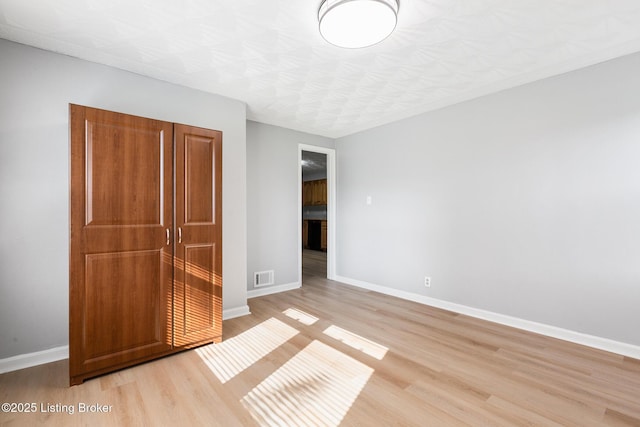 6515 Upper Hunters Trce, Louisville, KY 40216 - unfurnished bedroom featuring light wood-style floors, baseboards, and visible vents