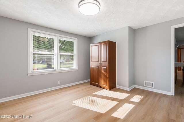 6515 Upper Hunters Trce, Louisville, KY 40216 - unfurnished bedroom featuring baseboards, light wood-style flooring, and visible vents