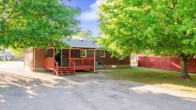 6515 Upper Hunters Trce, Louisville, KY 40216 - back of house with brick siding, a deck, fence, and a shingled roof