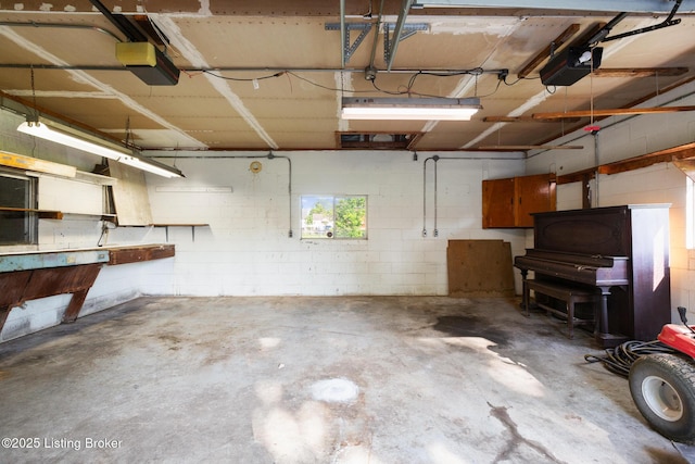 6515 Upper Hunters Trce, Louisville, KY 40216 - garage with concrete block wall and a garage door opener