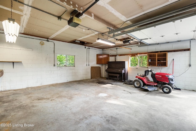 6515 Upper Hunters Trce, Louisville, KY 40216 - garage featuring concrete block wall and a garage door opener