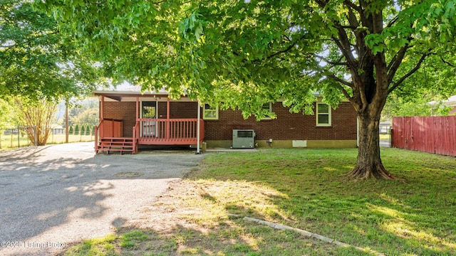 6515 Upper Hunters Trce, Louisville, KY 40216 - back of property with a yard, brick siding, fence, and a wooden deck