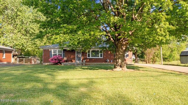 6515 Upper Hunters Trce, Louisville, KY 40216 - view of front of home featuring brick siding, driveway, fence, and a front lawn