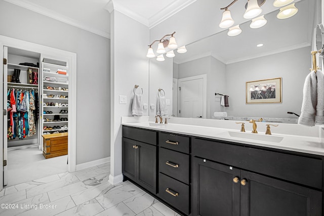 bathroom featuring crown molding, baseboards, marble finish floor, a sink, and double vanity
