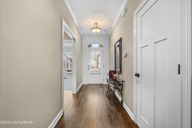 foyer with baseboards, ornamental molding, and dark wood finished floors