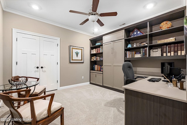 home office featuring crown molding, baseboards, light colored carpet, visible vents, and ceiling fan