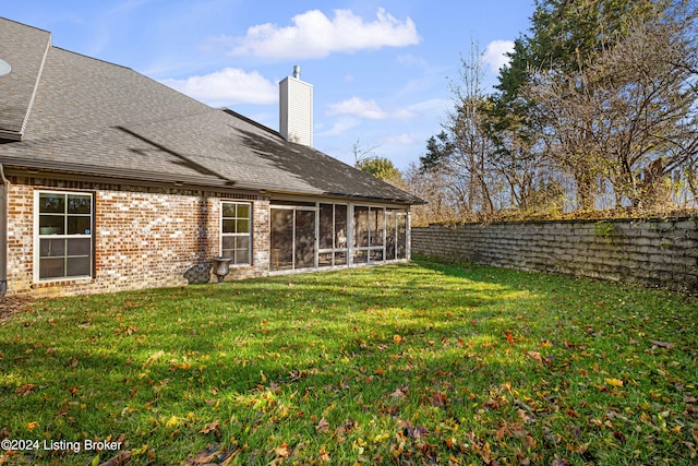 view of yard featuring a fenced backyard and a sunroom