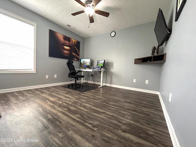 office with wood finished floors, a textured ceiling, ceiling fan, baseboards, and visible vents