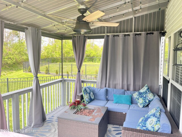 sunroom / solarium with an outdoor hangout area, a ceiling fan, and a healthy amount of sunlight