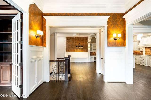 10900 Meeting St, Prospect, KY 40059 - hallway featuring dark wood-style flooring, crown molding, wallpapered walls, arched walkways, and wainscoting