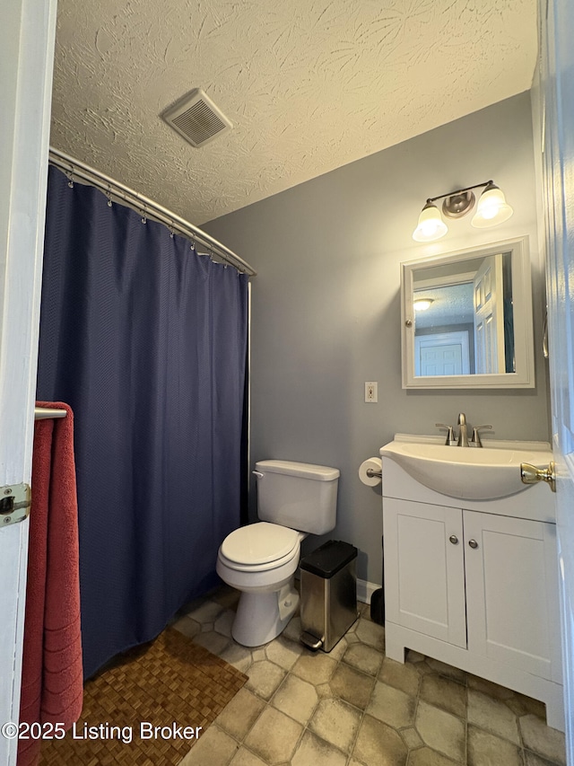 bathroom with visible vents, a shower with curtain, toilet, a textured ceiling, and vanity
