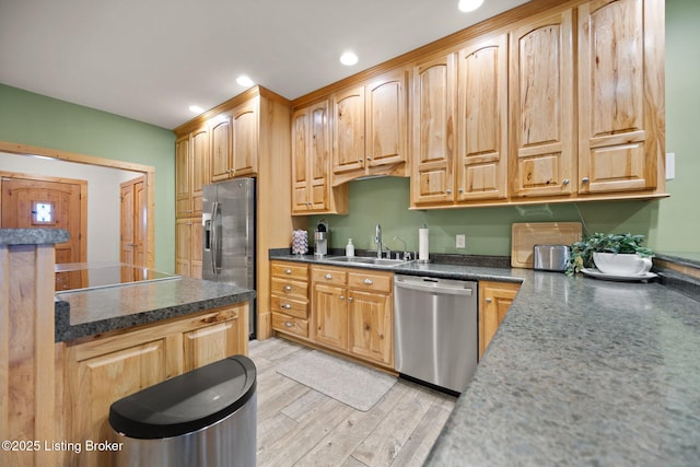 105 Moutardier Woods Way, Leitchfield, KY 42754 - kitchen featuring dark countertops, a sink, stainless steel appliances, and light wood-style floors
