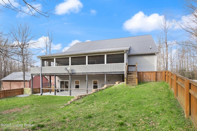 105 Moutardier Woods Way, Leitchfield, KY 42754 - rear view of house with a fenced backyard, a sunroom, and a lawn