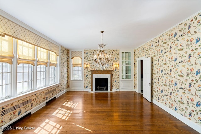 unfurnished living room featuring baseboards, wallpapered walls, and crown molding