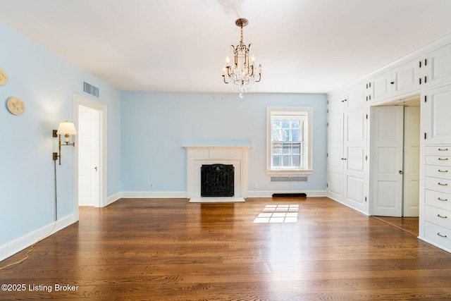 unfurnished living room with visible vents, baseboards, a chandelier, dark wood finished floors, and a fireplace