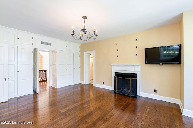 unfurnished living room featuring visible vents, baseboards, a notable chandelier, dark wood-style flooring, and a fireplace with flush hearth