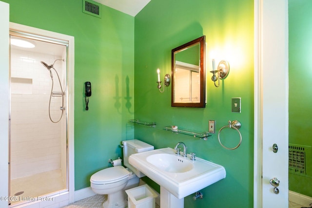 full bathroom with a sink, visible vents, toilet, and a stall shower