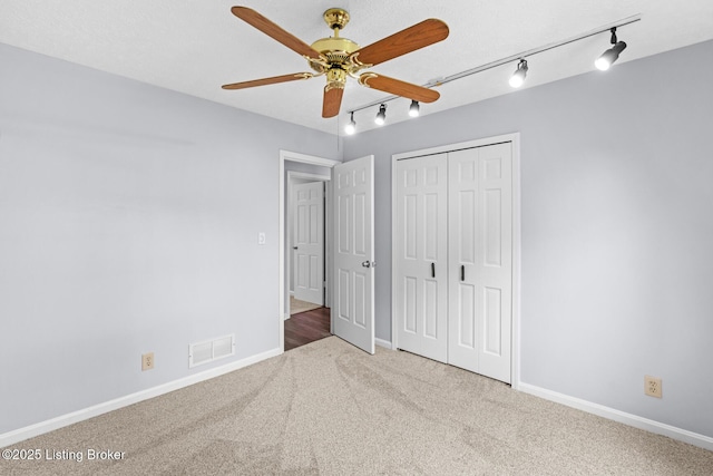 4904 Ruby Way, Shepherdsville, KY 40165 - unfurnished bedroom featuring rail lighting, carpet floors, a closet, baseboards, and a ceiling fan