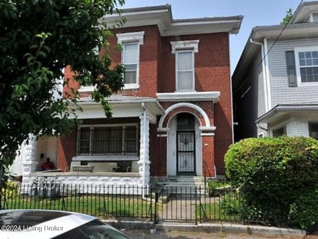 1921 W Chestnut St, Louisville, KY 40203 - italianate house featuring a fenced front yard and brick siding