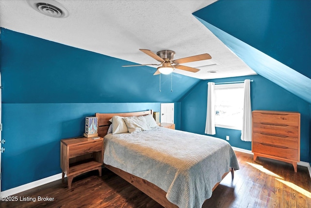 bedroom featuring baseboards, a textured ceiling, visible vents, lofted ceiling, and wood finished floors