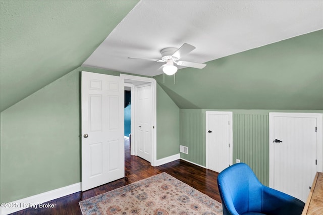 home office featuring wood finished floors, ceiling fan, baseboards, and visible vents