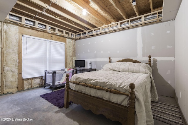 bedroom featuring concrete flooring