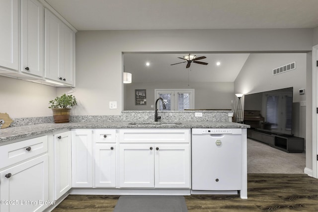 kitchen with a sink, visible vents, dishwasher, a peninsula, and ceiling fan