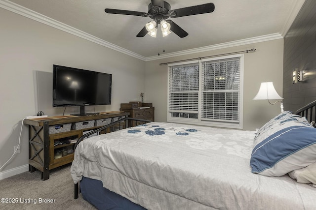 carpeted bedroom featuring baseboards, ornamental molding, and a ceiling fan