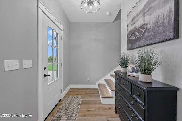 3965 Broadford Rd, Clarkson, KY 42726 - doorway to outside featuring an inviting chandelier, baseboards, light wood finished floors, and stairs