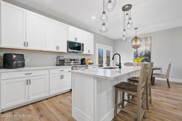 3965 Broadford Rd, Clarkson, KY 42726 - kitchen featuring white cabinetry, a sink, appliances with stainless steel finishes, and light wood-type flooring