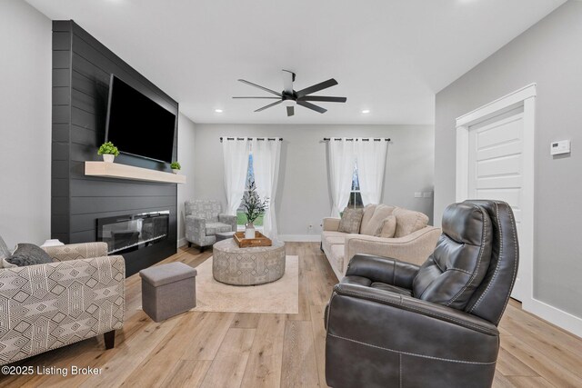 3965 Broadford Rd, Clarkson, KY 42726 - living room with baseboards, ceiling fan, a glass covered fireplace, and wood finished floors