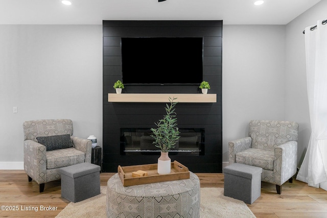 3965 Broadford Rd, Clarkson, KY 42726 - living area featuring a large fireplace, wood finished floors, and recessed lighting