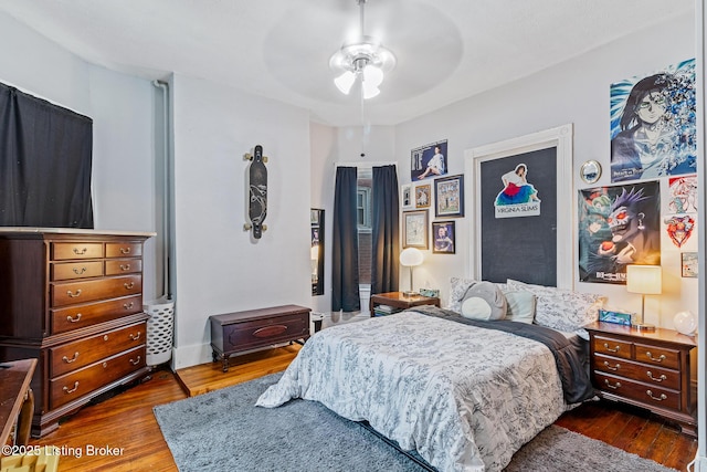 bedroom with wood finished floors and a ceiling fan
