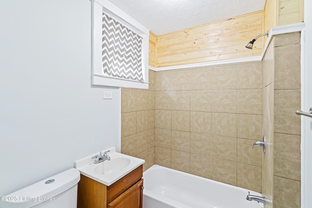 bathroom with toilet, a textured ceiling, vanity, and shower / bathing tub combination