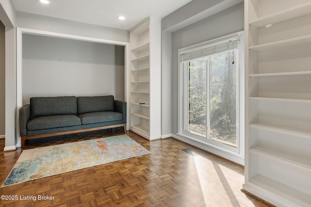 living area featuring recessed lighting and baseboards