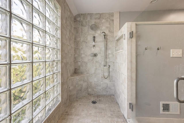 bathroom with visible vents, a shower stall, and plenty of natural light