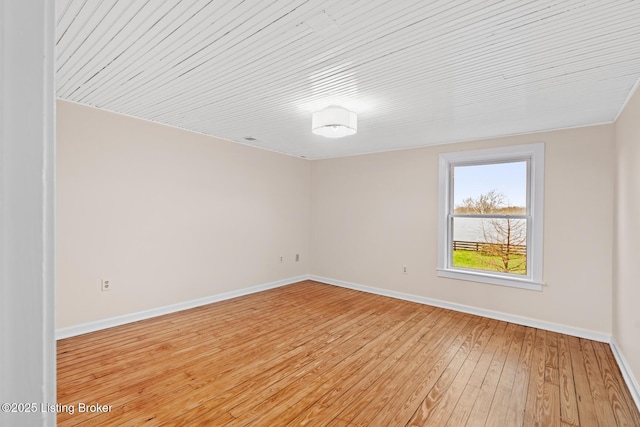 unfurnished room with light wood-style floors and baseboards