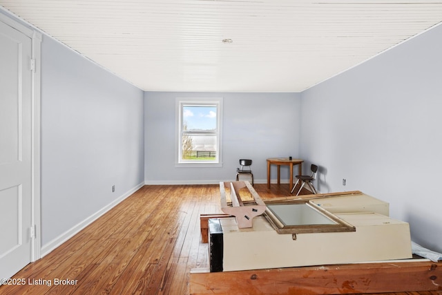 empty room featuring hardwood / wood-style flooring and baseboards