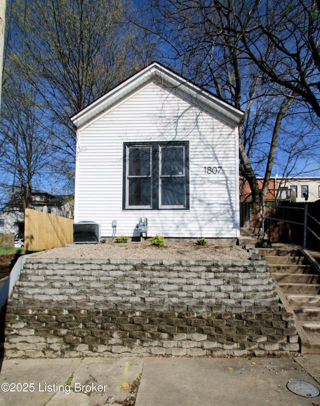 view of home's exterior with central AC and fence