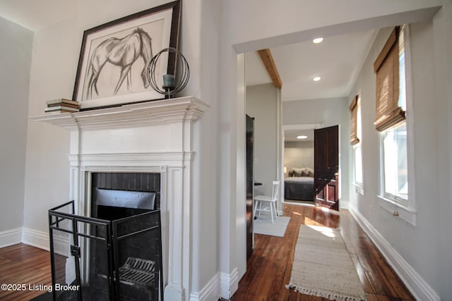 interior space with dark wood-type flooring, baseboards, and recessed lighting