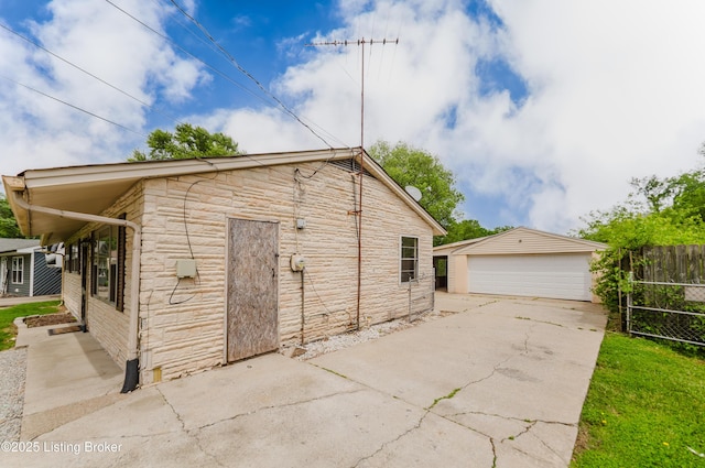 230 S Skyline Dr, Louisville, KY 40229 - view of side of property featuring stone siding, an outbuilding, a garage, and fence