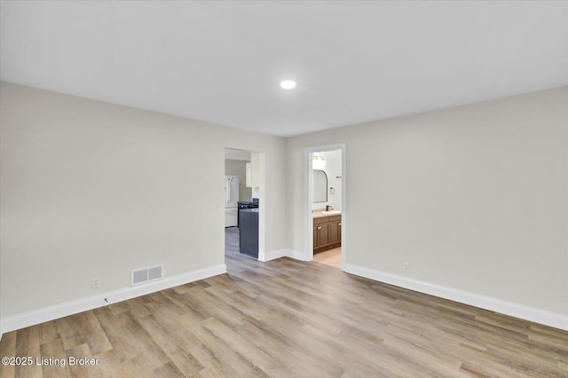 unfurnished room with recessed lighting, light wood-style floors, visible vents, and baseboards