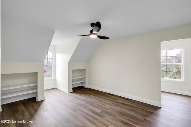 additional living space with plenty of natural light, wood finished floors, and built in shelves