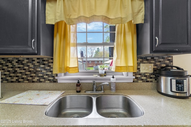 2410 Mammoth Way, Louisville, KY 40299 - kitchen featuring dark cabinetry, tasteful backsplash, and a sink